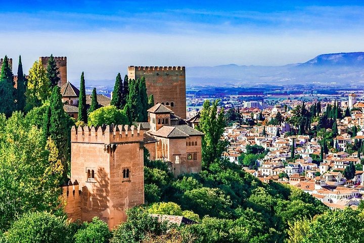 Alhambra towers rising above woodland with Granada beyond