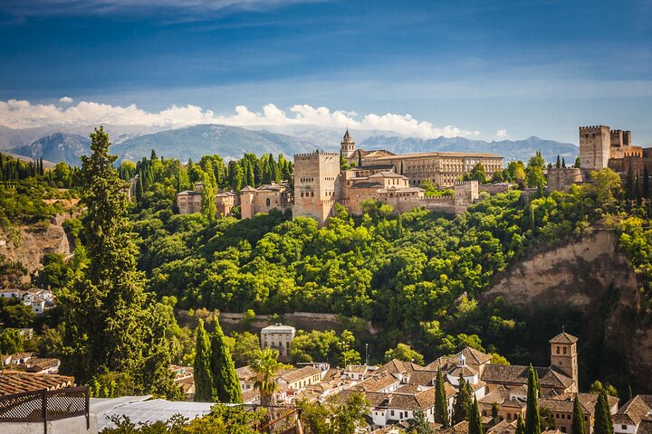 The Alhambra’s walls and towers above the green hillside