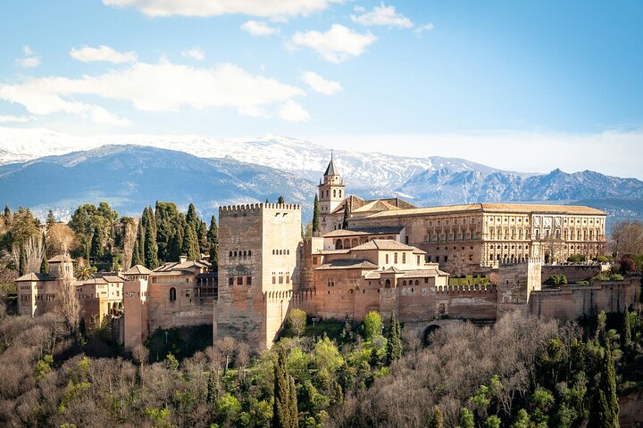 Alhambra palaces and towers with snow-covered mountains behind