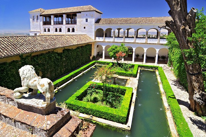 Clipped garden beds and reflecting pools in a Generalife courtyard