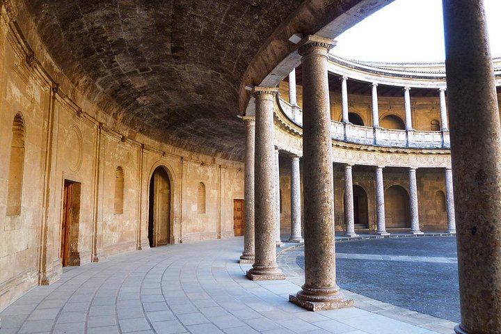Stone columns around the circular courtyard of Charles V Palace