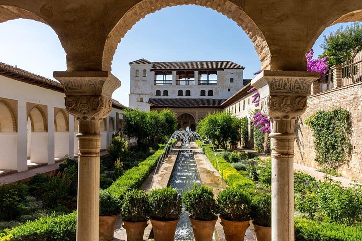 The Generalife’s water channel and gardens seen through an arch