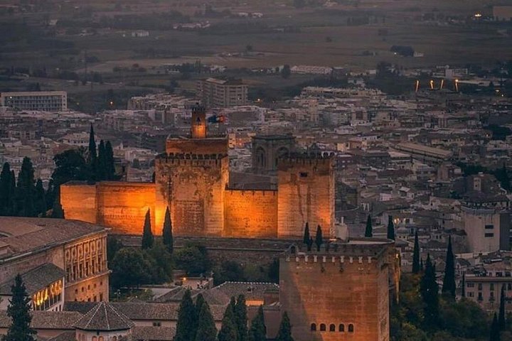 The Alhambra’s illuminated fortress towers at dusk