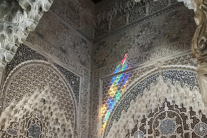 Fine plaster carvings and Arabic inscriptions illuminated by coloured light