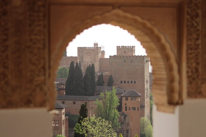 Alhambra towers framed by a decorated arch